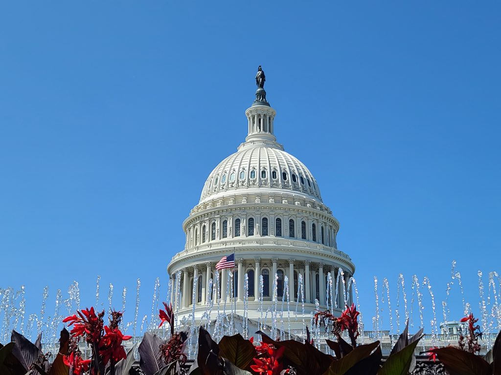 A fountain flows in front of the United States Capitol Building