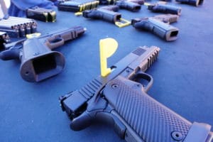 A handgun with a safety flag inserted into its barrel indicating it is unloaded during SHOT Show 2022's range day