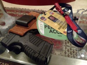 A reporter's pistol is holstered in a leather holster