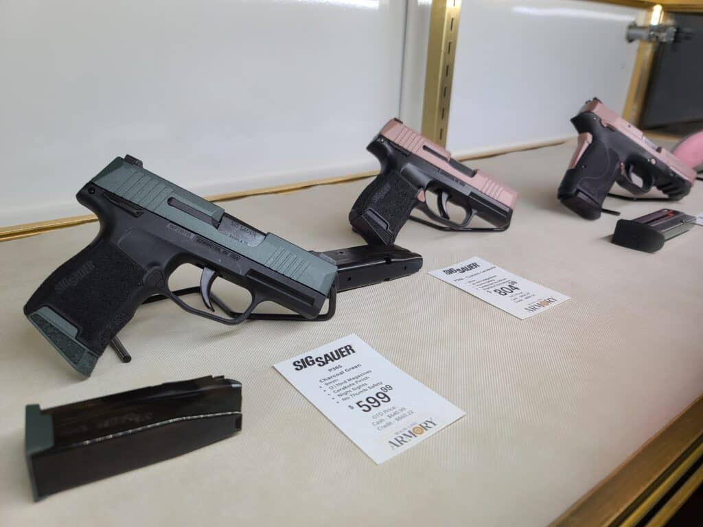 Different colored handguns on display in a gun store during April 2023