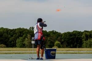 Matthew Kutz breaks a clay target as it flies through the air