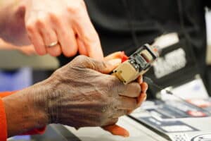 A woman examines a pistol at the 2024 NRA Annual Meeting