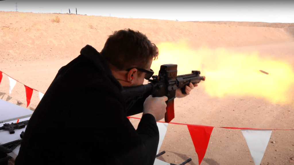 A handsome young man fires a machinegun at a range outside Las Vegas, Nevada