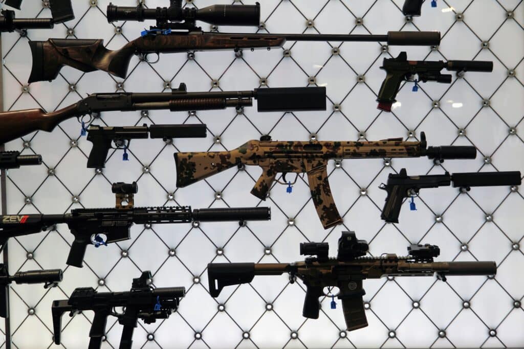 A collection of suppressed firearms on display at the SilencerCo booth during the 2025 NRA Annual Meeting